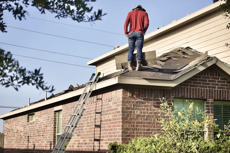 Professional roofer working on a residential roof in Delafield